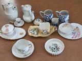 many different types of tea cups and saucers on the table