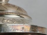 a close up of a silver plate on a table