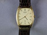 a close up of a wrist watch with a brown strap