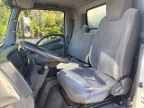 the interior of a van with two seats and a steering wheel