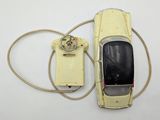 a yellow toy car with a phone attached to it