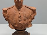 an image of a clay bust of a man on a pedestal