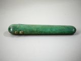 a close up of a small green object on a white surface