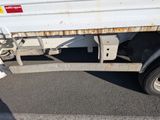 a white truck with rust on the side of it