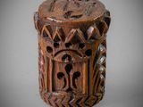 a close up of a wooden object with carvings on it