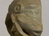 a sculpture of a fish head on a stick