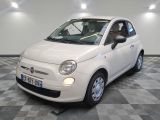 a small white car parked on a checkered floor