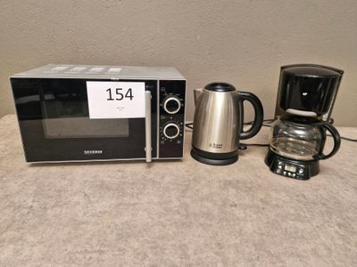 un micro-ondes et une cafetière posés sur une table