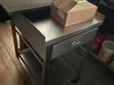 a table with a box on top of it in a kitchen