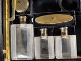 three bottles of perfume sitting in a case on a table