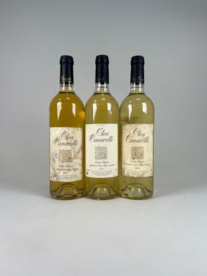 three bottles of wine sitting next to each other on a table