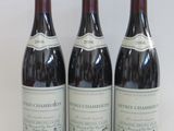 three bottles of wine sitting on top of a table next to each other