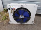 an air conditioner sitting on top of a sidewalk next to a building