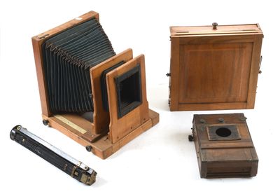 three old cameras sitting next to each other on a white surface
