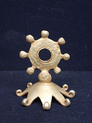 gold plated metal candle holder with a star design on top of it