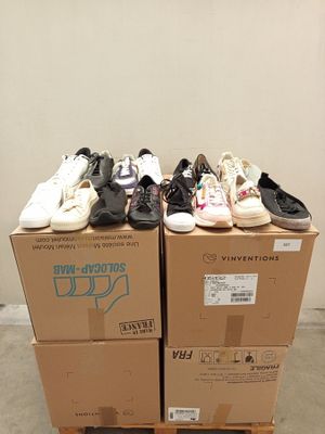 many pairs of shoes sitting on top of a cardboard box
