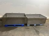 two large stainless steel sinks sitting on pallets in a warehouse