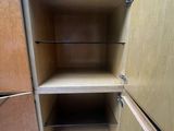 a wooden cabinet with shelves in the corner of the room