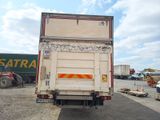 a truck that is parked in a lot with other trucks in the background
