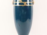 a blue vase with a gold stripe on it