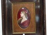 an old picture of a woman in a red dress in a wooden frame