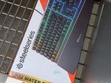 a box of water resistant keyboard sitting on the floor
