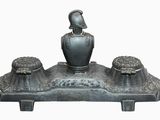 a statue of a woman sitting on top of a table