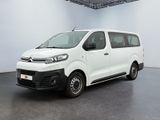 the white van is parked in a large room with a black floor