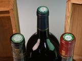 three bottles of wine sitting in a wooden box