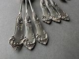 five spoons that are sitting on a table