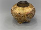 an image of a gold vase with a design on it