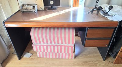 a desk with a chair and a computer on top of it