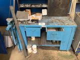 a blue workbench with tools on it in a garage