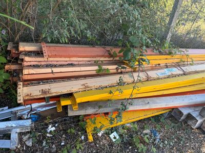 a pile of wood sitting on the ground next to a fence