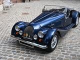 a blue sports car parked on a cobblestone street