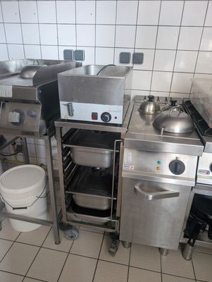 a small kitchen with a stove, sink, and other appliances