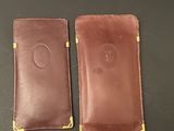 two brown leather cases sitting side by side on a table