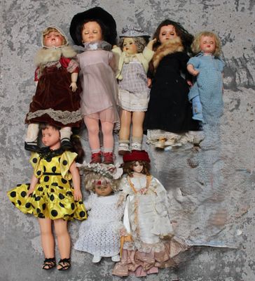 a lot of dolls that are sitting on a wall