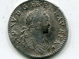 une vieille pièce d'argent avec un visage de femme dessus