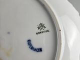 a white plate with a blue and white design on it