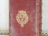 a red book with a gold emblem on it