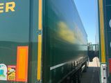 two large semi trucks parked side by side in a parking lot