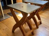 two tables that are sitting on a wooden floor