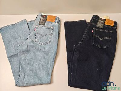 two pairs of levi ' s jeans are sitting on a table