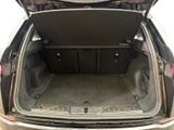 the back of a car with the trunk open and the back door open
