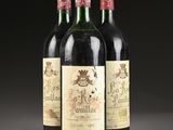 three bottles of wine are lined up on a table