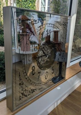 a picture of a clock that is on a window sill