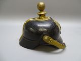 a black and gold helmet on a white table
