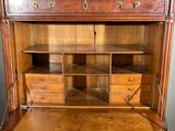 a wooden cabinet with drawers and drawers on top of it