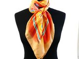 yellow and orange silk scarf with stripes on a mannequin neck